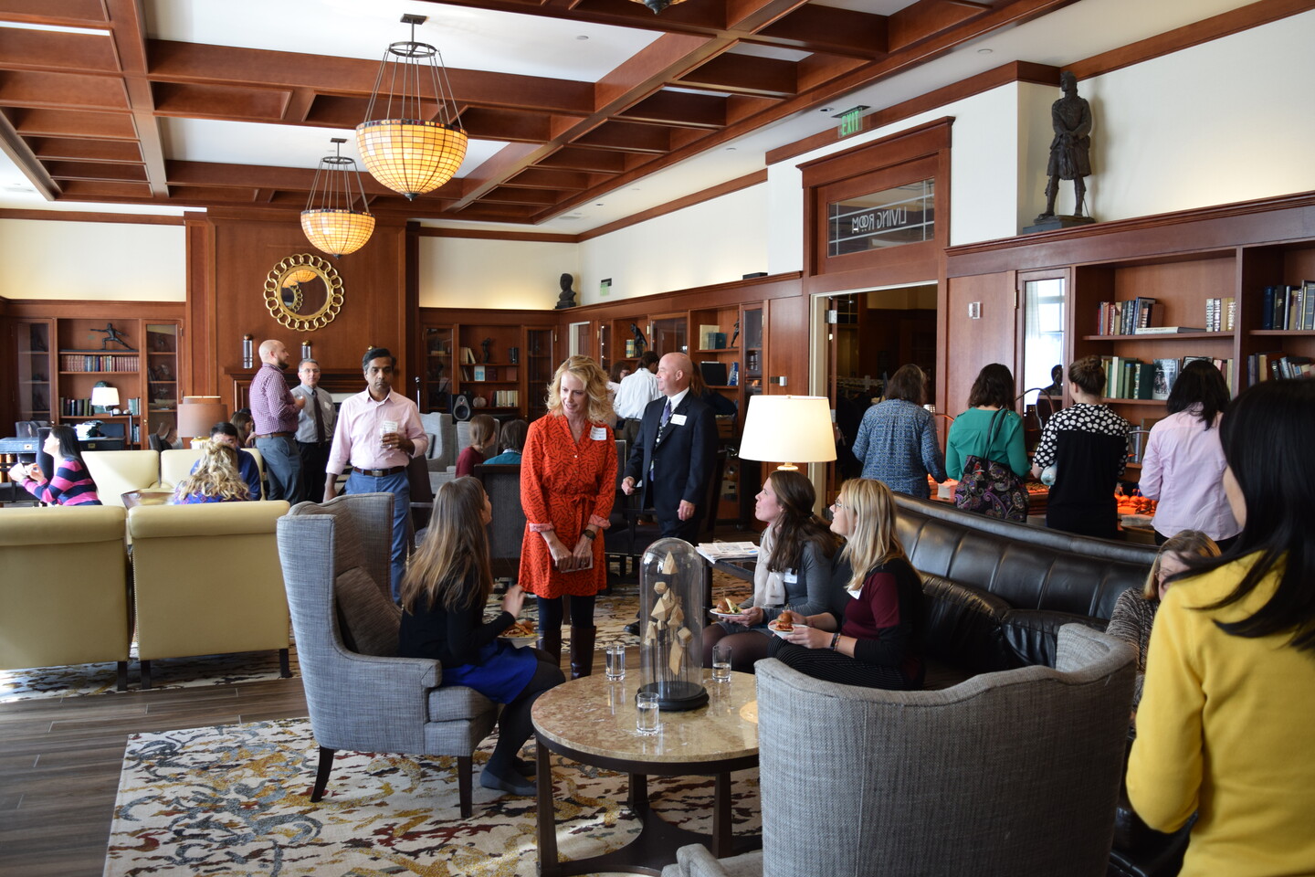 Be in the Know VIP participants mingling indoors with food at a VIP reception