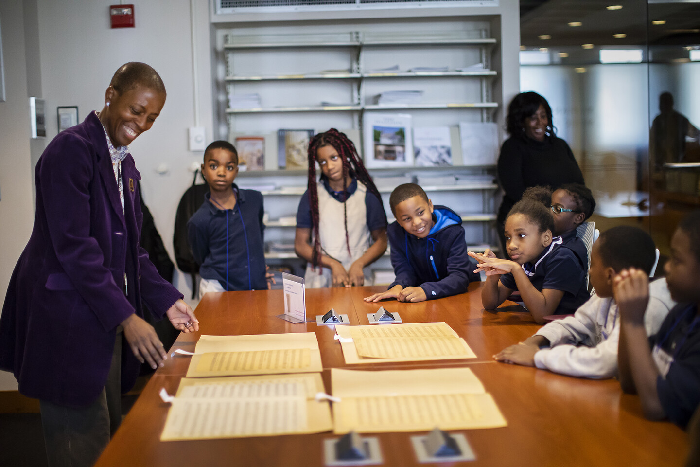 Penn-Libraries-April-James-laughing-while-showing-Philadelphia-elementary-school-students-sheet-music-for-Marian-Anderson-song.