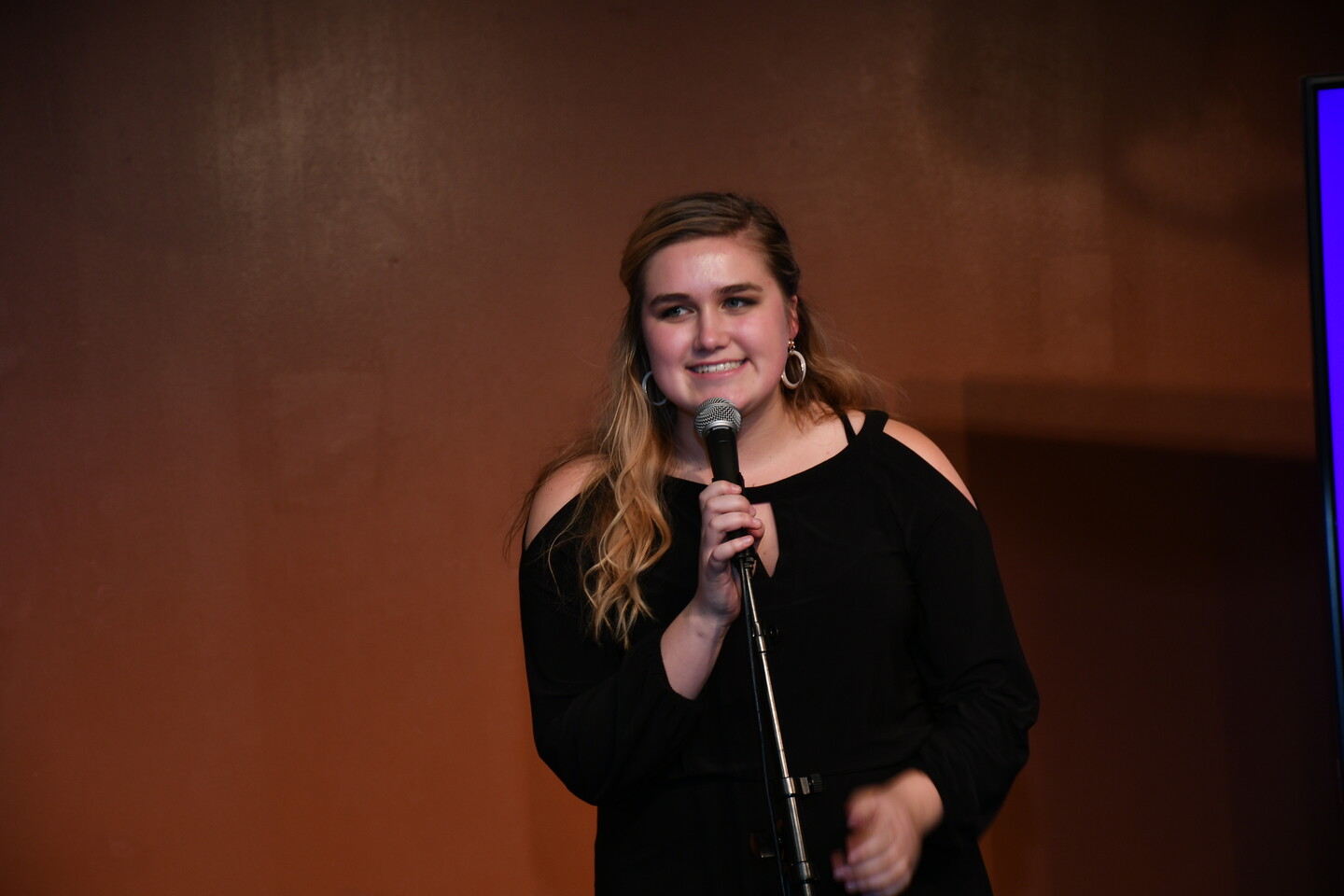 Priscilla Felton at a microphone smiling