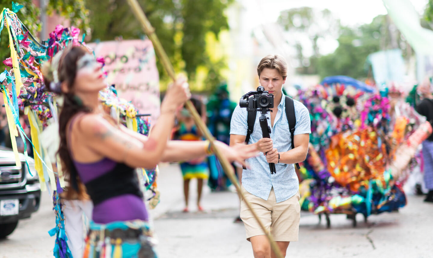 student videographer filming parade