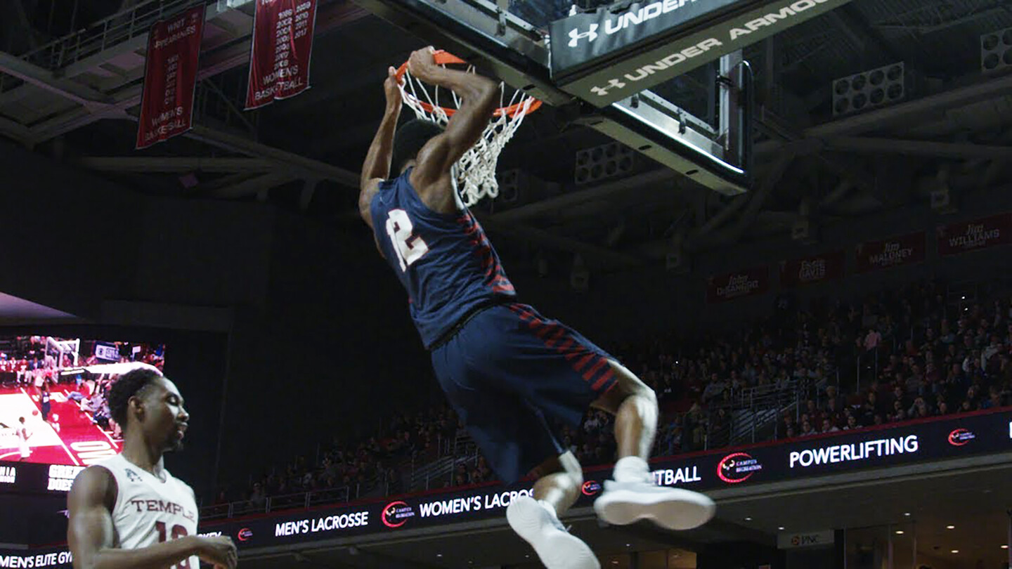 Junior guard Devon Goodman dunks the ball against Temple.