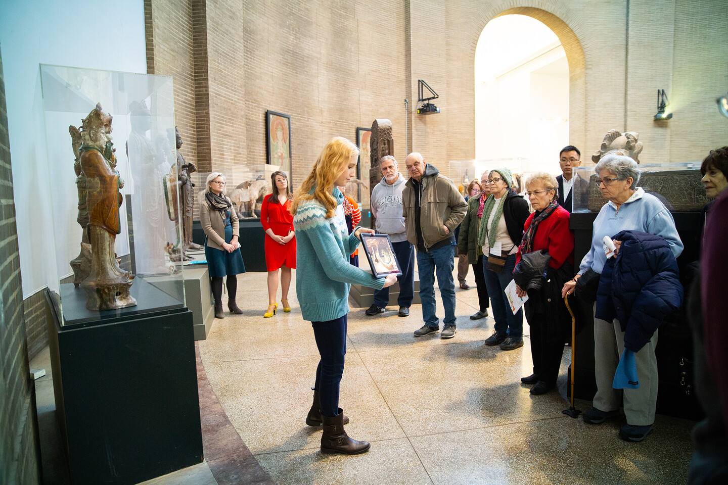 A group gathered for a tour in the China Gallery of the Penn Museum