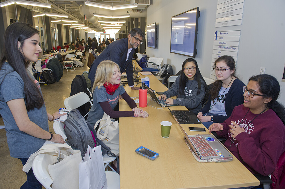 Gutmann and Kumar sit with student participants and listen to them describe work