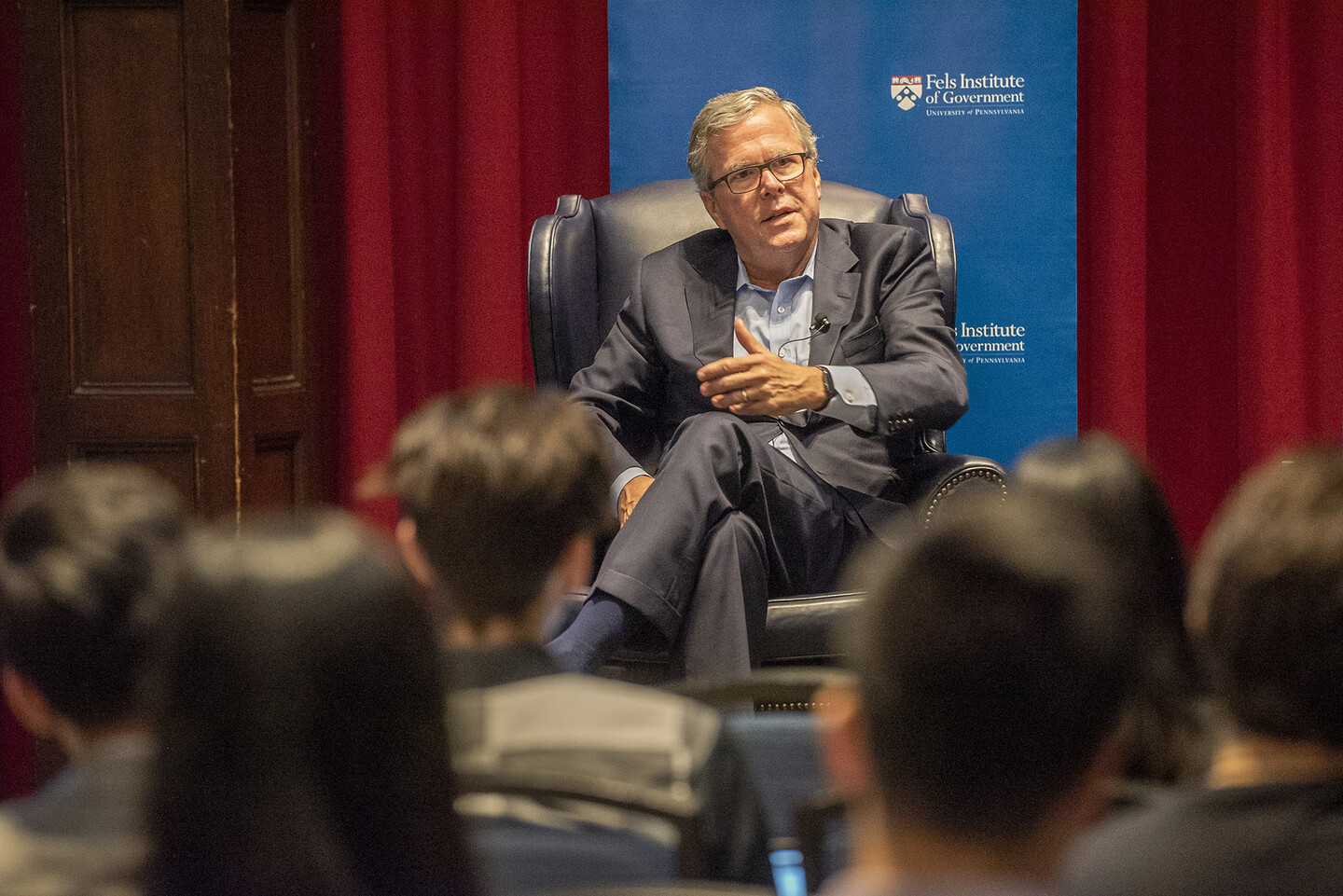 Jeb Bush seated on stage view from audience