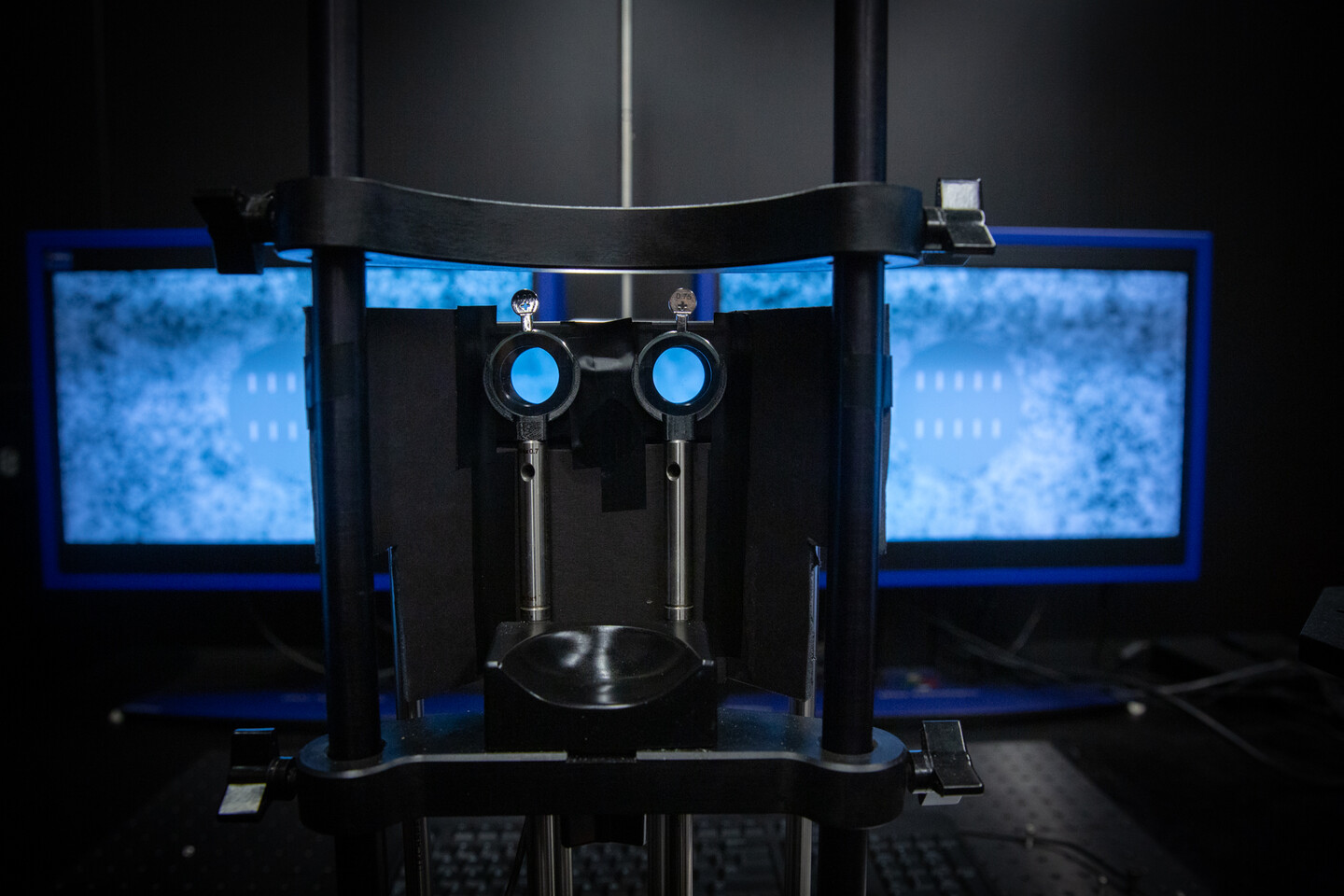 A machine that allows a person to see different images with each eye at the same time. Screens appear blurred in the background.