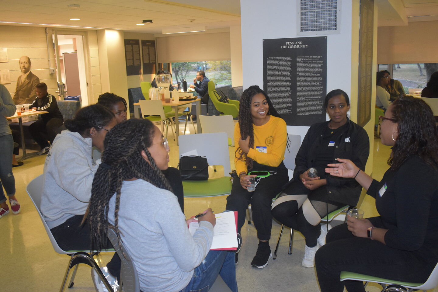 A group sits in a circle listening to one member speak