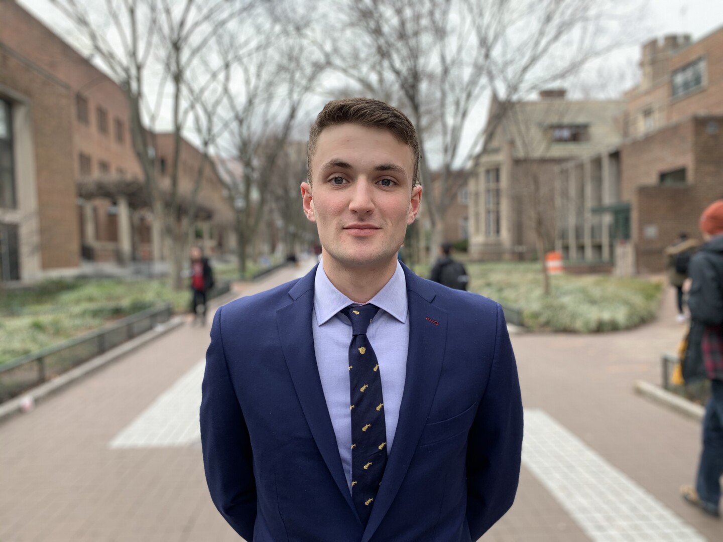 Student standing on Locust Walk 