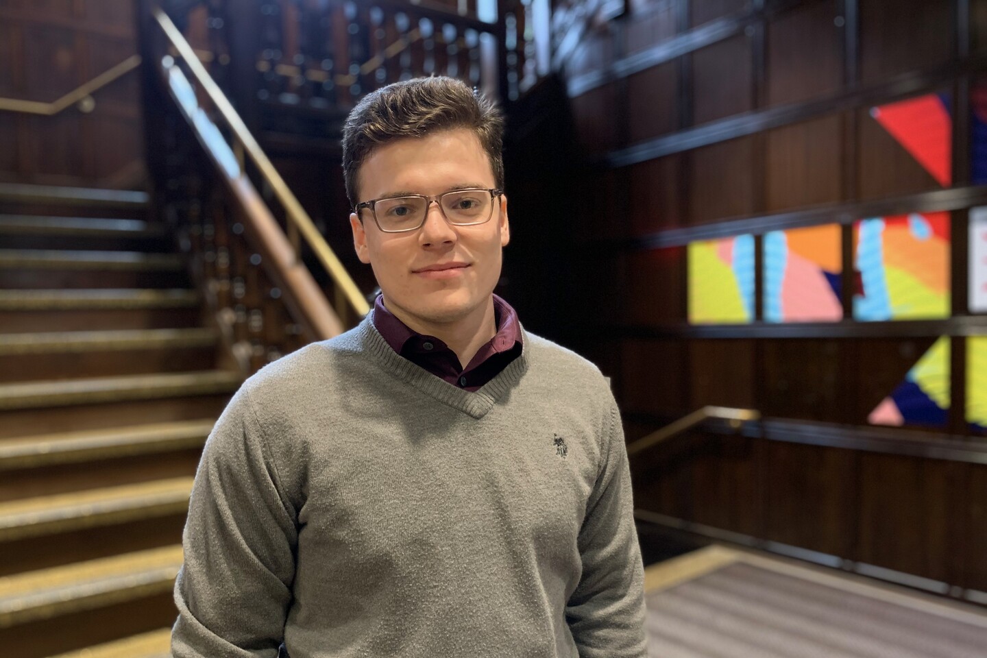 Student standing in stair landing. 