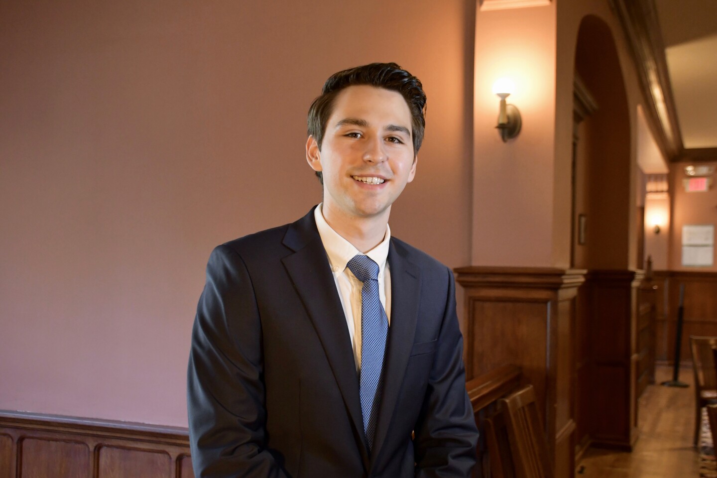 Student standing in a stairwell. 