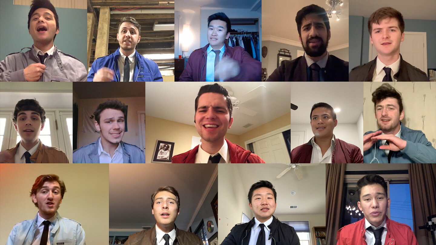 Fourteen students singing in a music video. 
