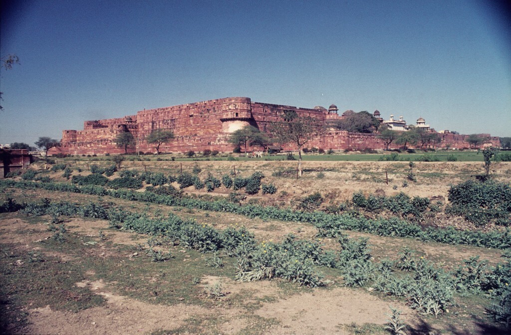 A red-brick walled city with turrets