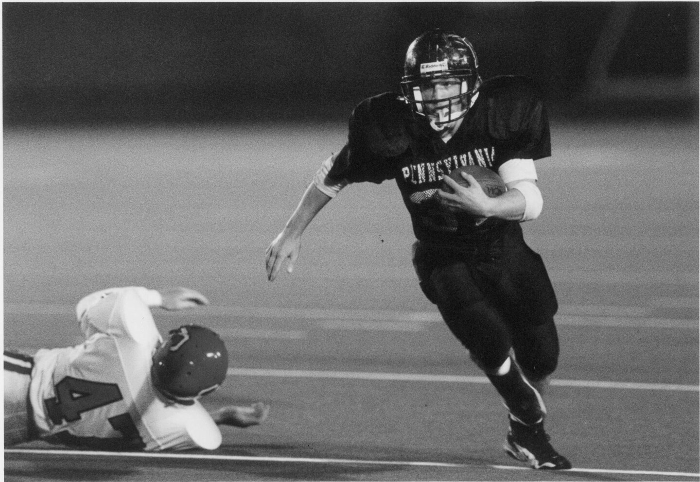 Tim Ortman dodges a defender and runs in the open field during a game.