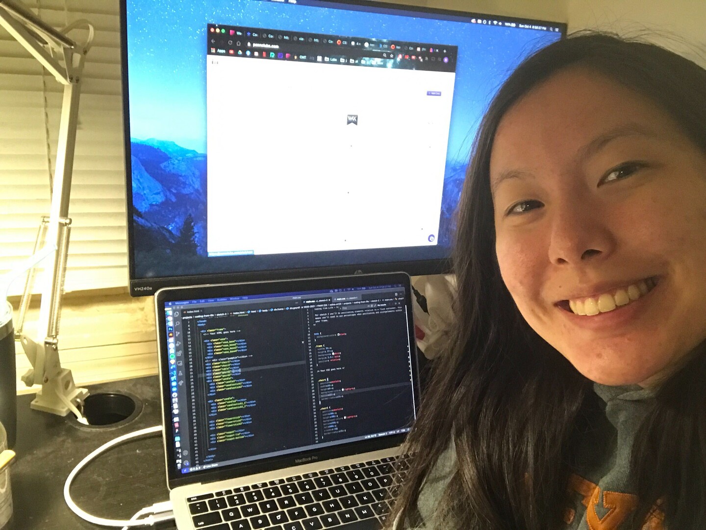 Student with laptop and large monitor.