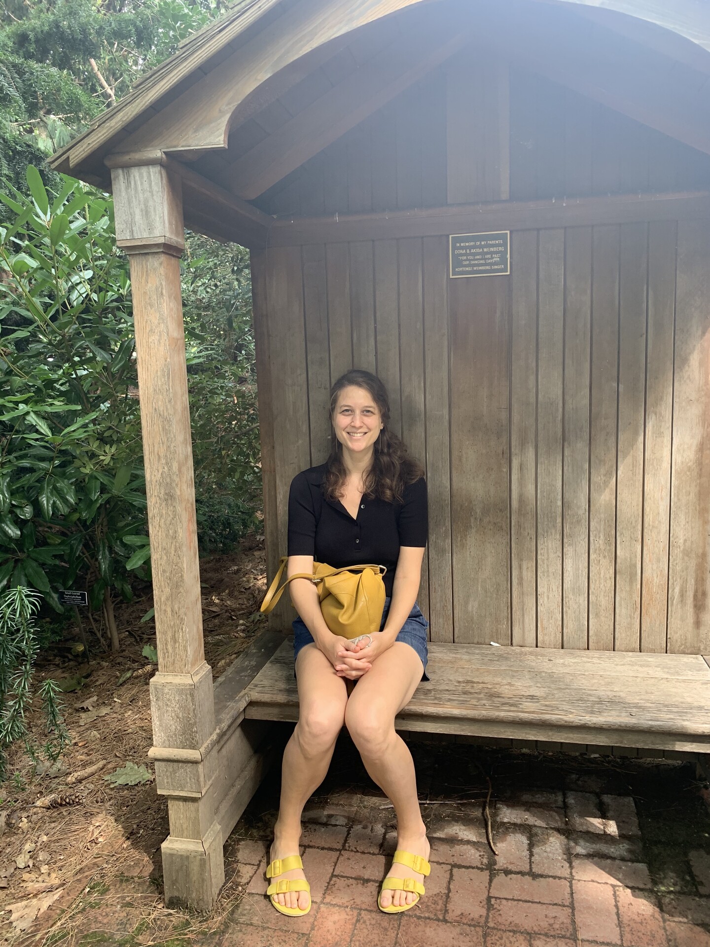 Woman sits in a shelter in the woods