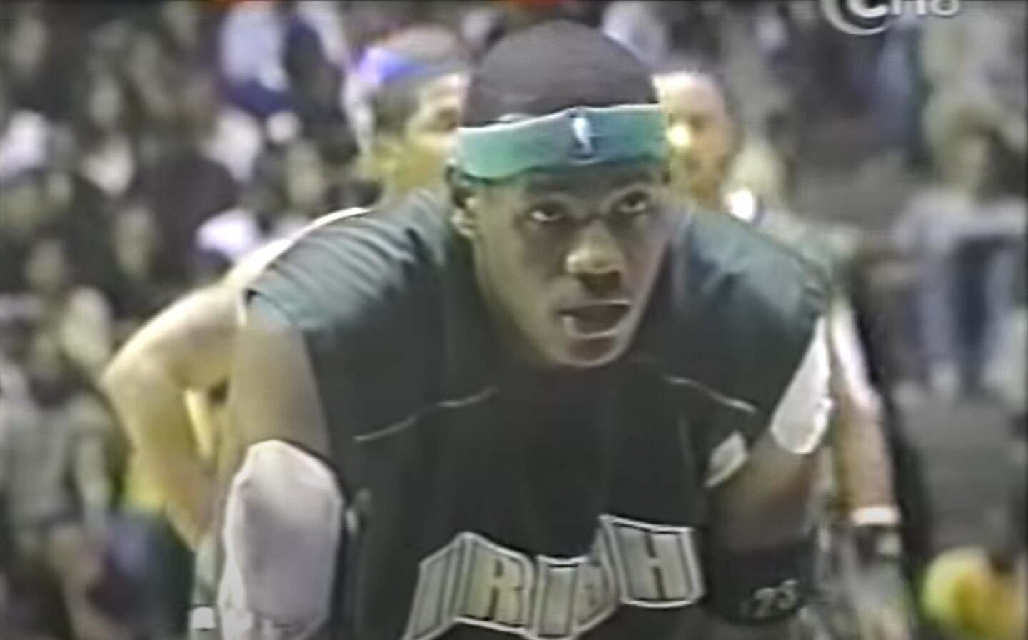 LeBron James bends over his his hands on his knees at the foul line.