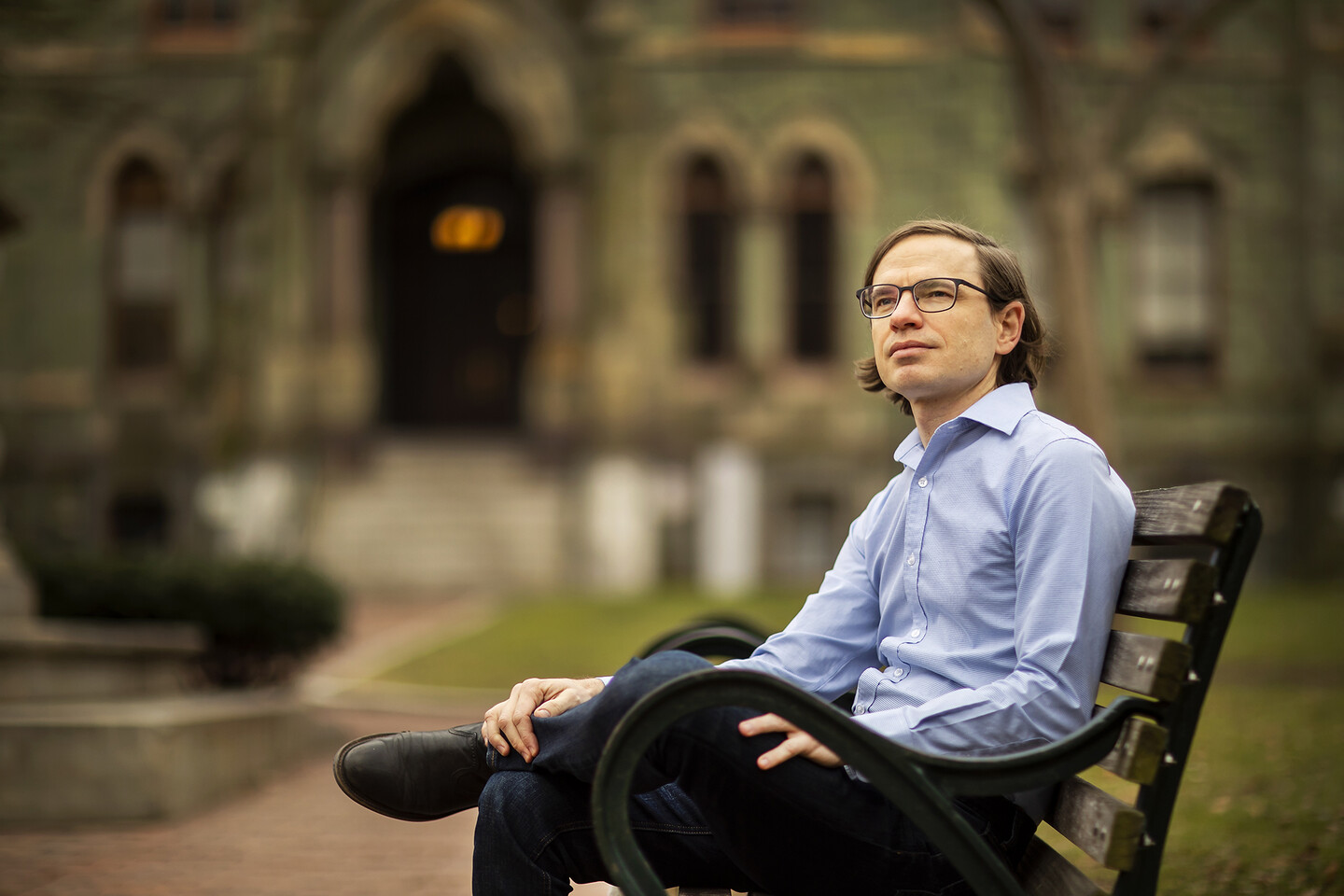 jared farmer sitting on a bench on college green