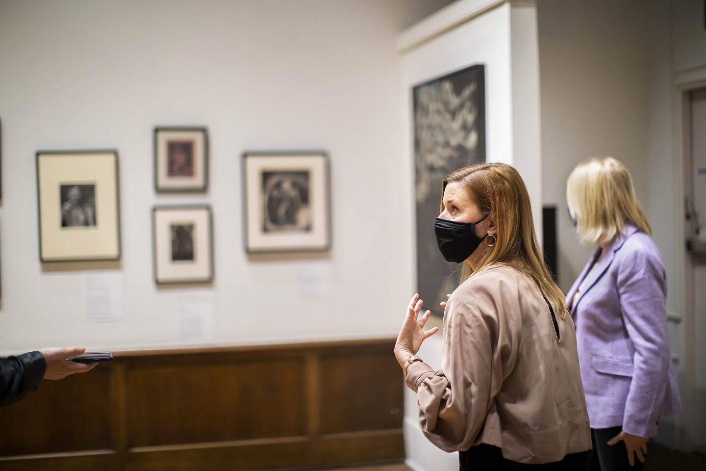 Two people standing in an art gallery.