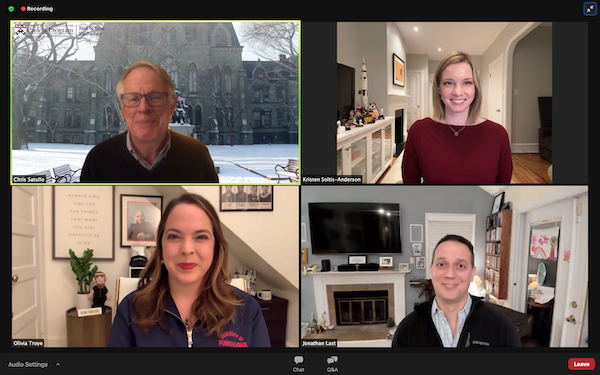 A Zoom call shows four screens two men and two women smiling from their homes.