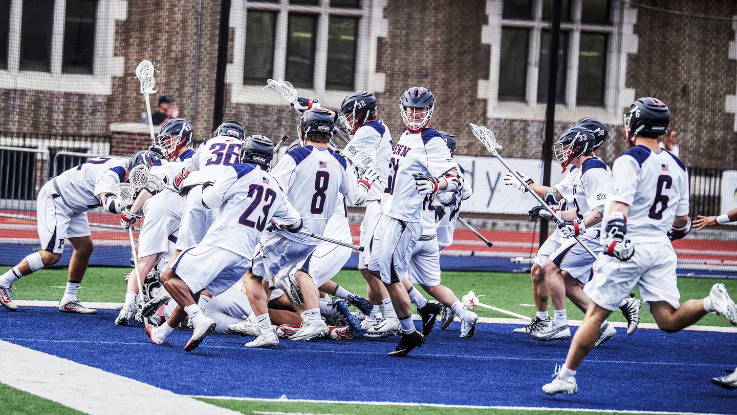 Members of the men's labrosse team celebrate after a big goal.
