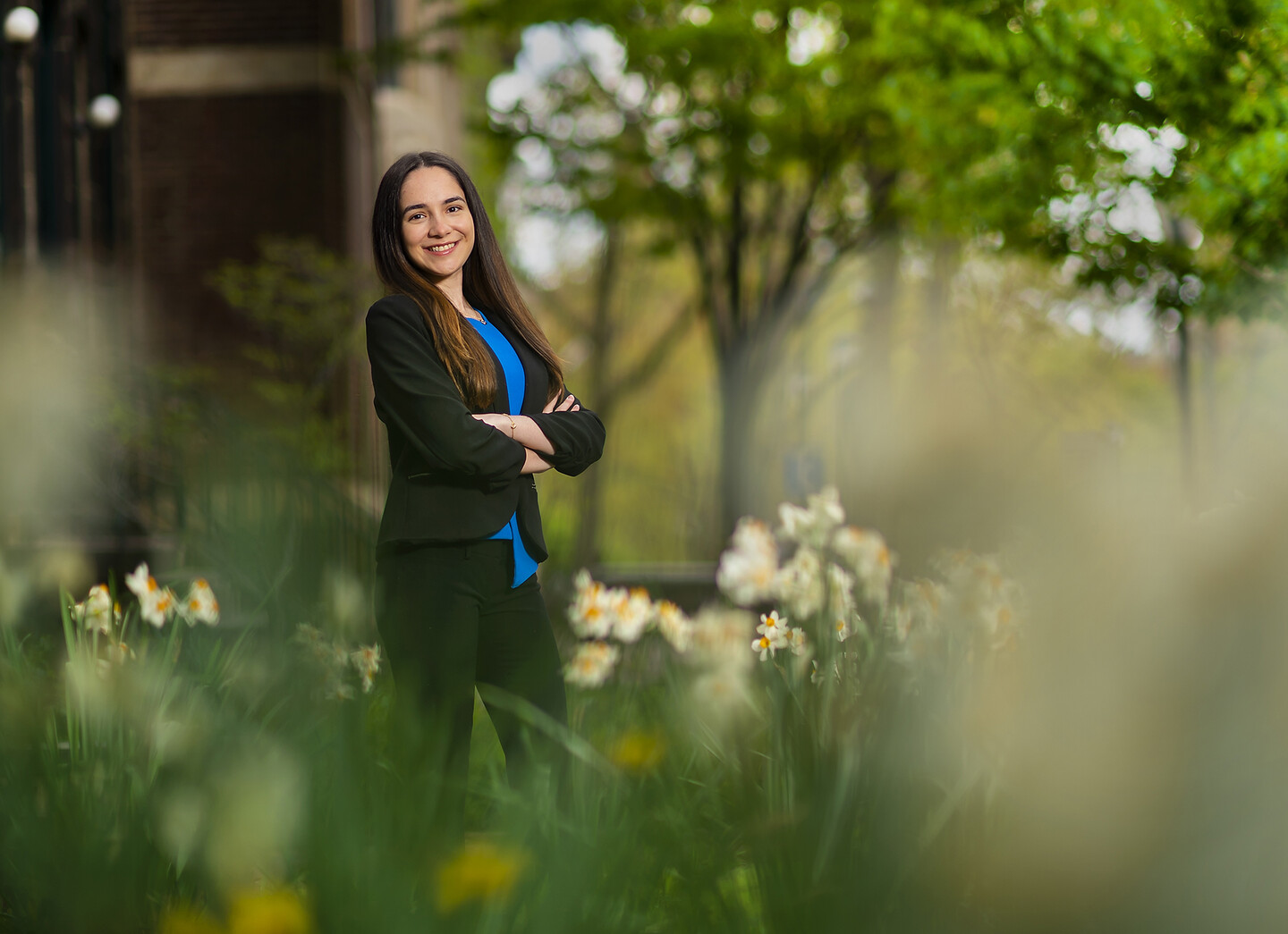 Student standing outside surrounded by flowers