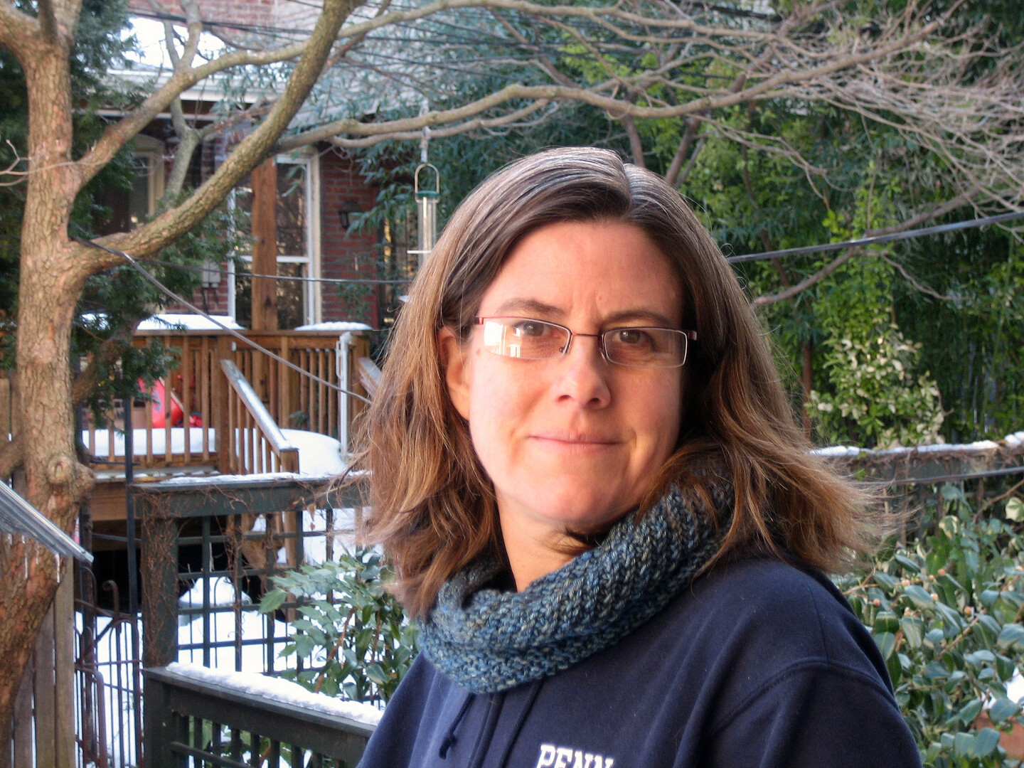 Karen Detlefsen on a back porch in snow.