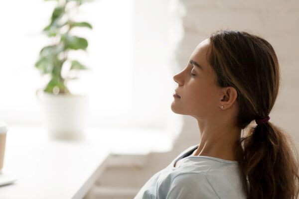 Woman meditating in sunlight