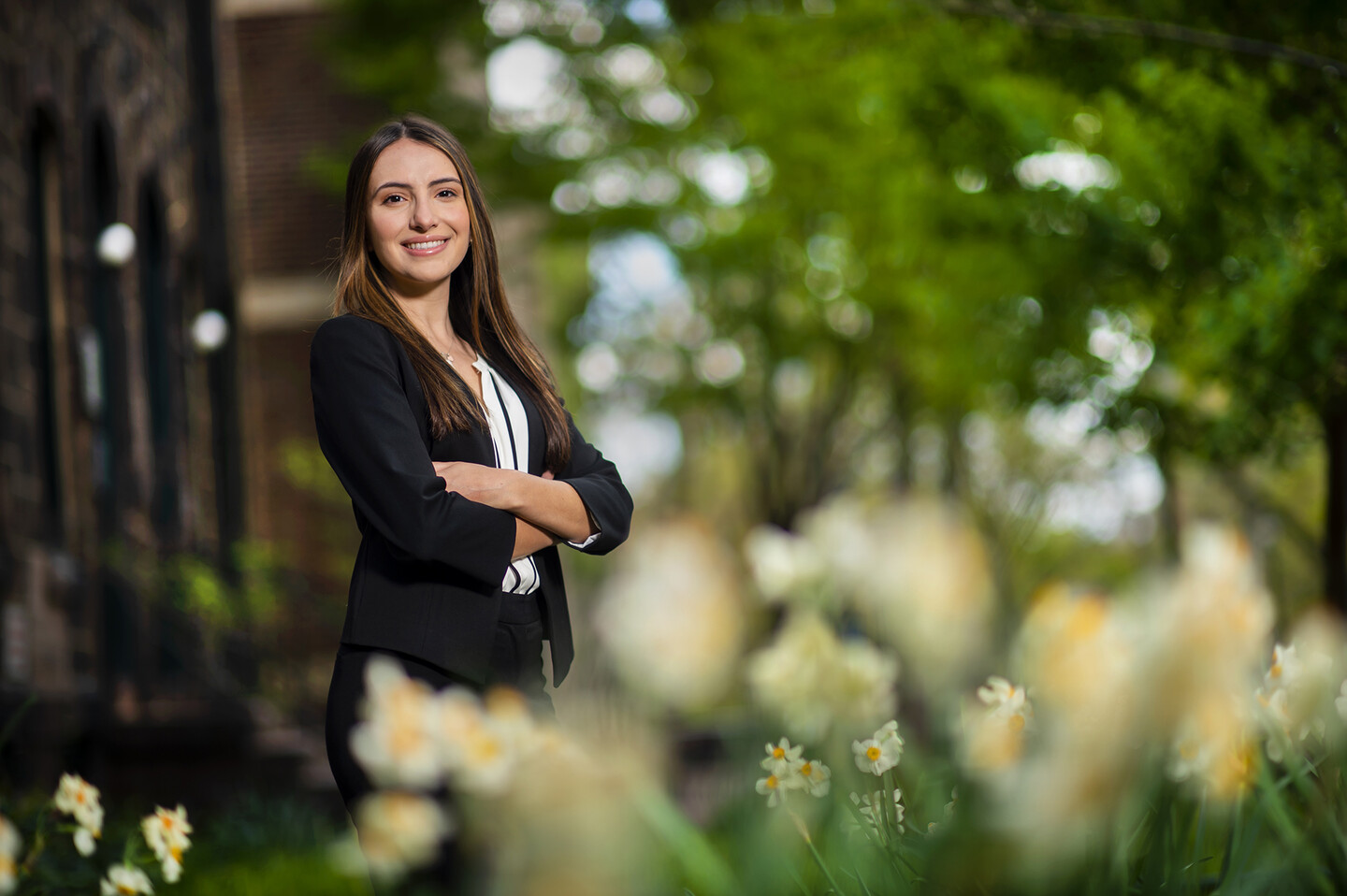 Student standing outside surrounded by flowers