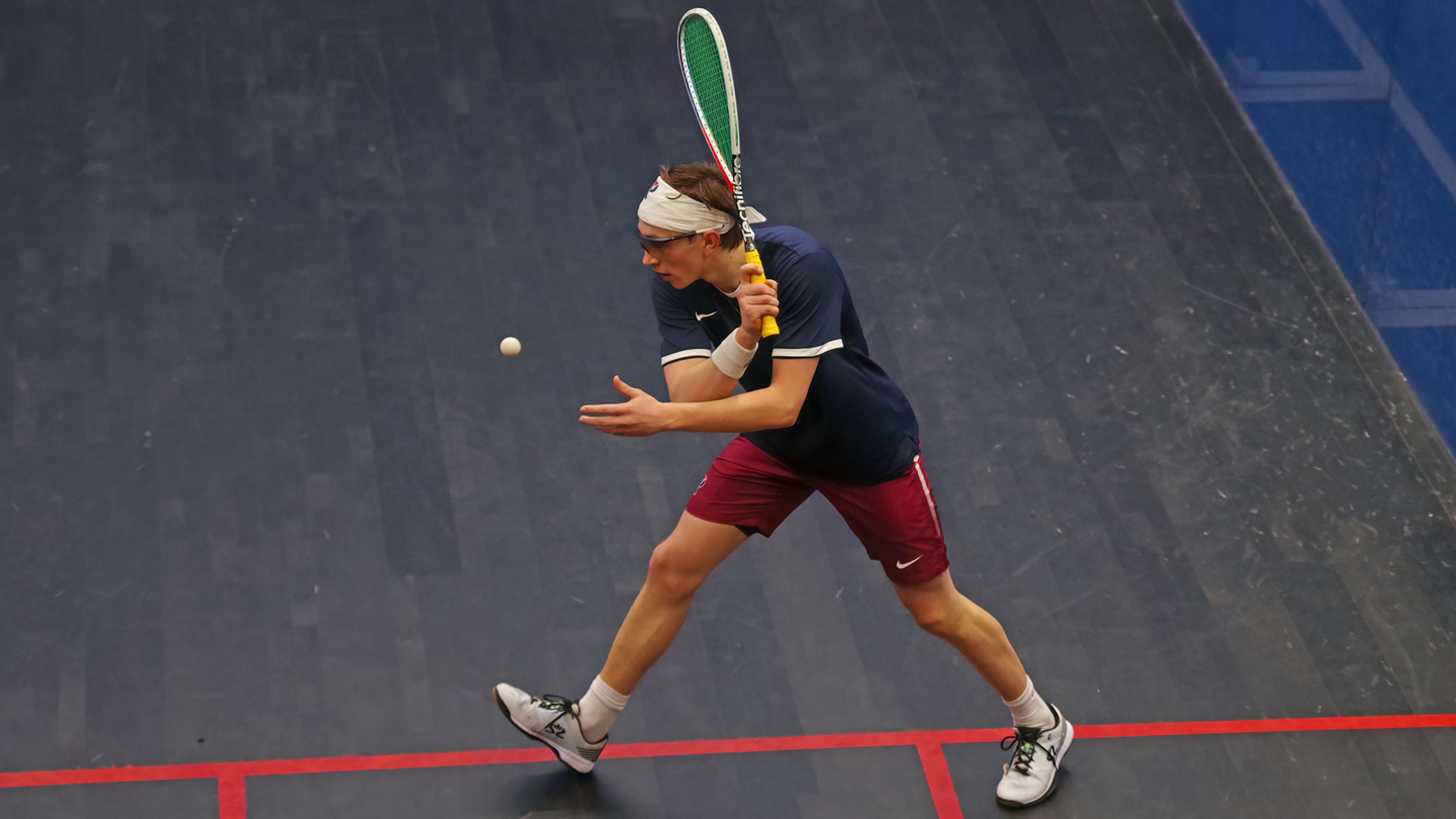Andrew Douglas prepares to swing at the ball during a squash match.