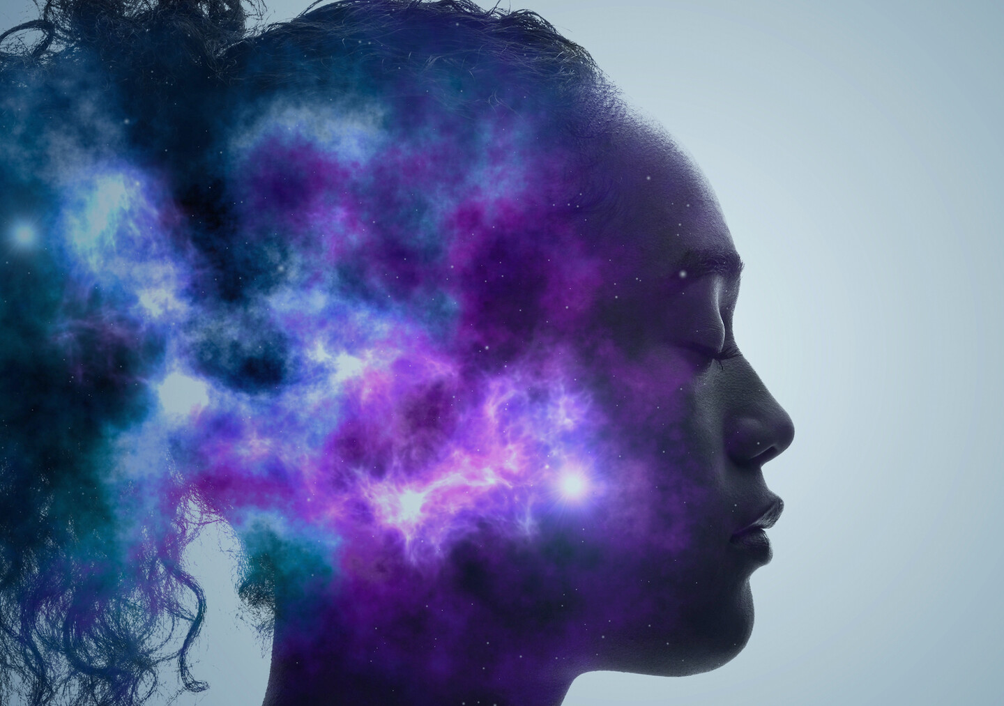 A composite image that supposed to be looking inside the mind of the person pictured. In the mind it shows blue and purple coloration, with specks of light breaking through.