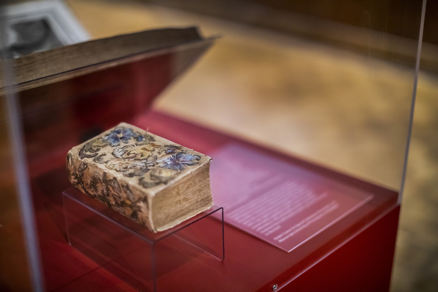 embroidered book in a glass case