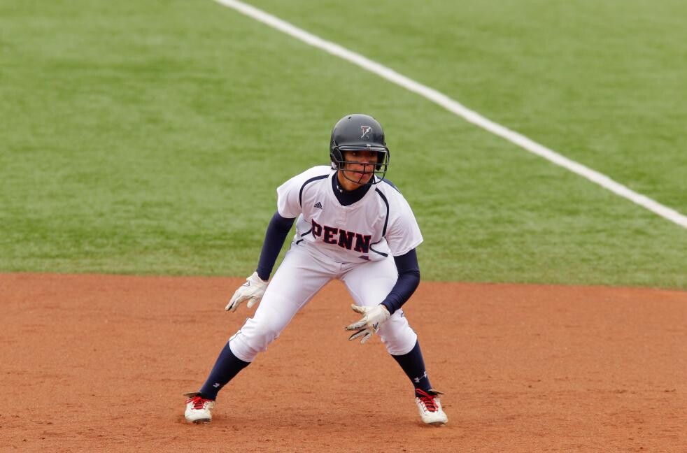 baseball player crouching between bases on the diamond