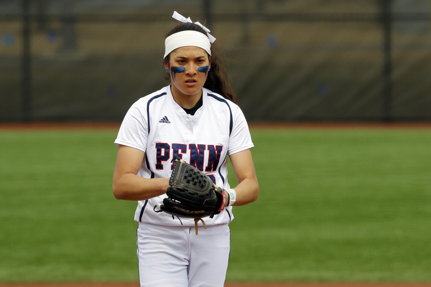 Borden stands on the mound with her hand and the ball in her glove.
