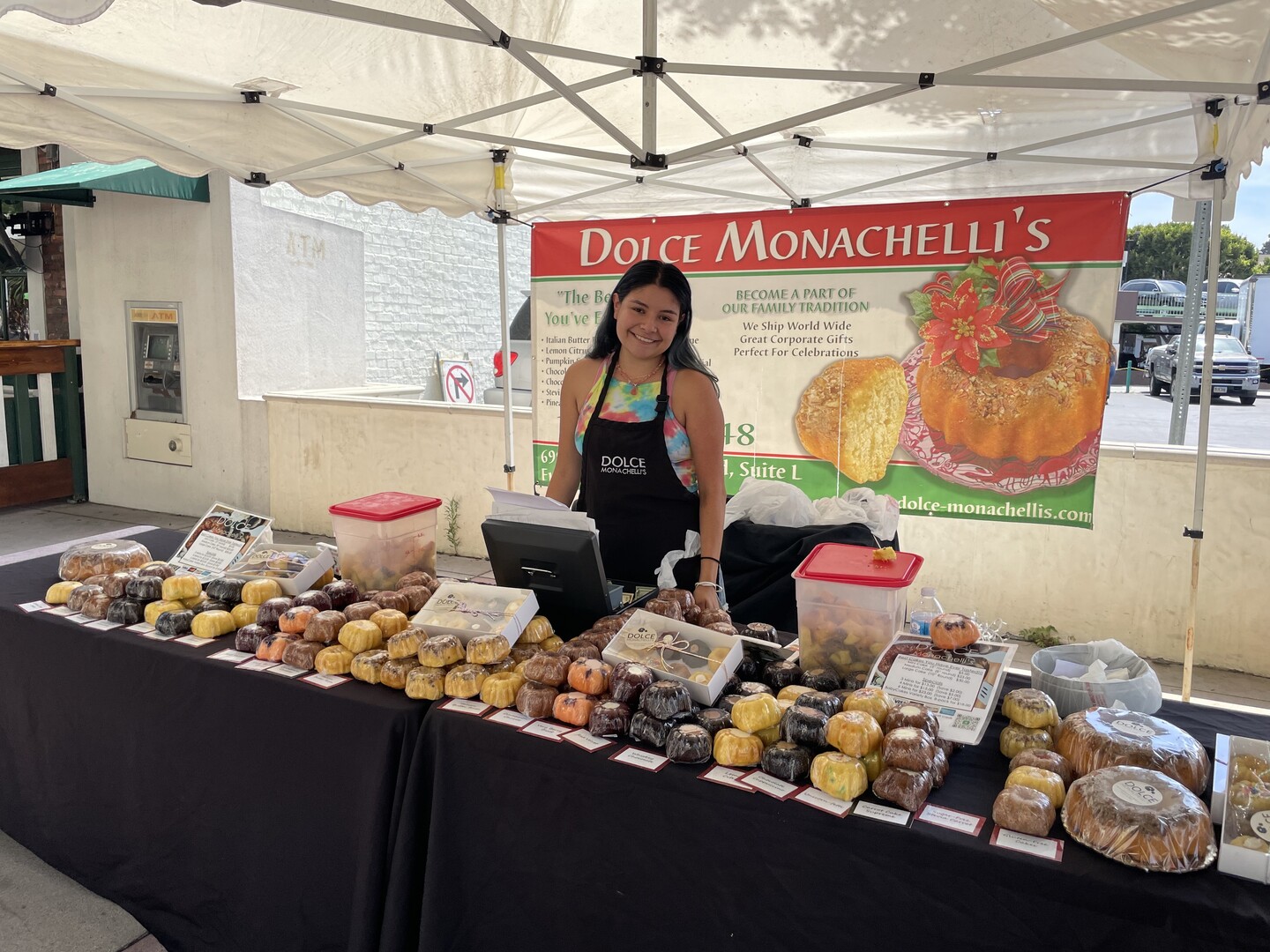 Student standing behind a table filled with baked goods