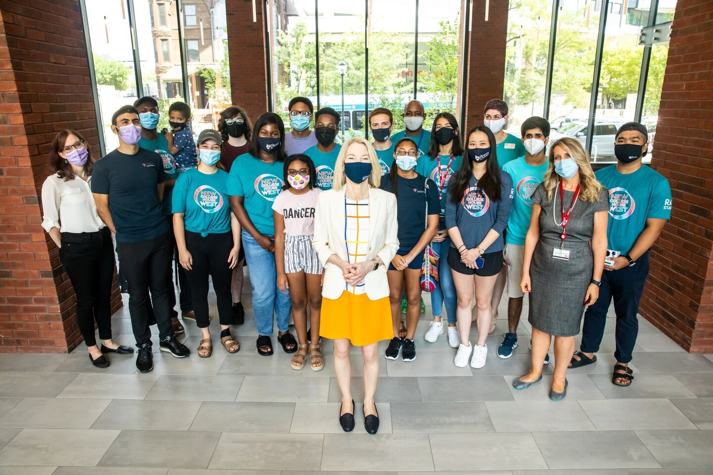 Penn President Amy Gutmann poses in front of staff of New College House West