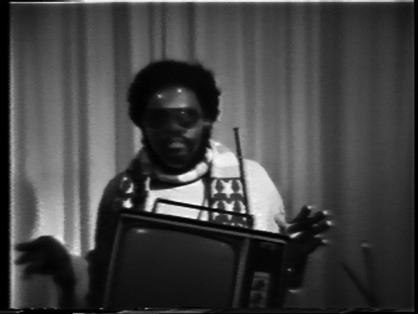 Ulysses Jenkins in sunglasses behind a television