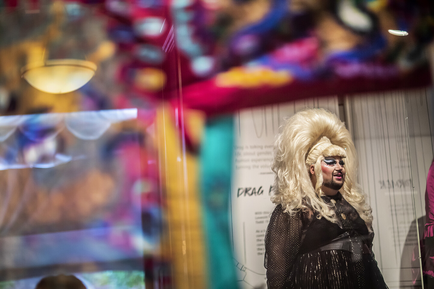 person with big wig standing in gallery