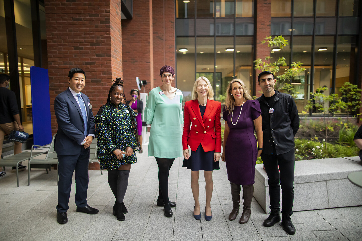 five people standing in residence hall courtyard
