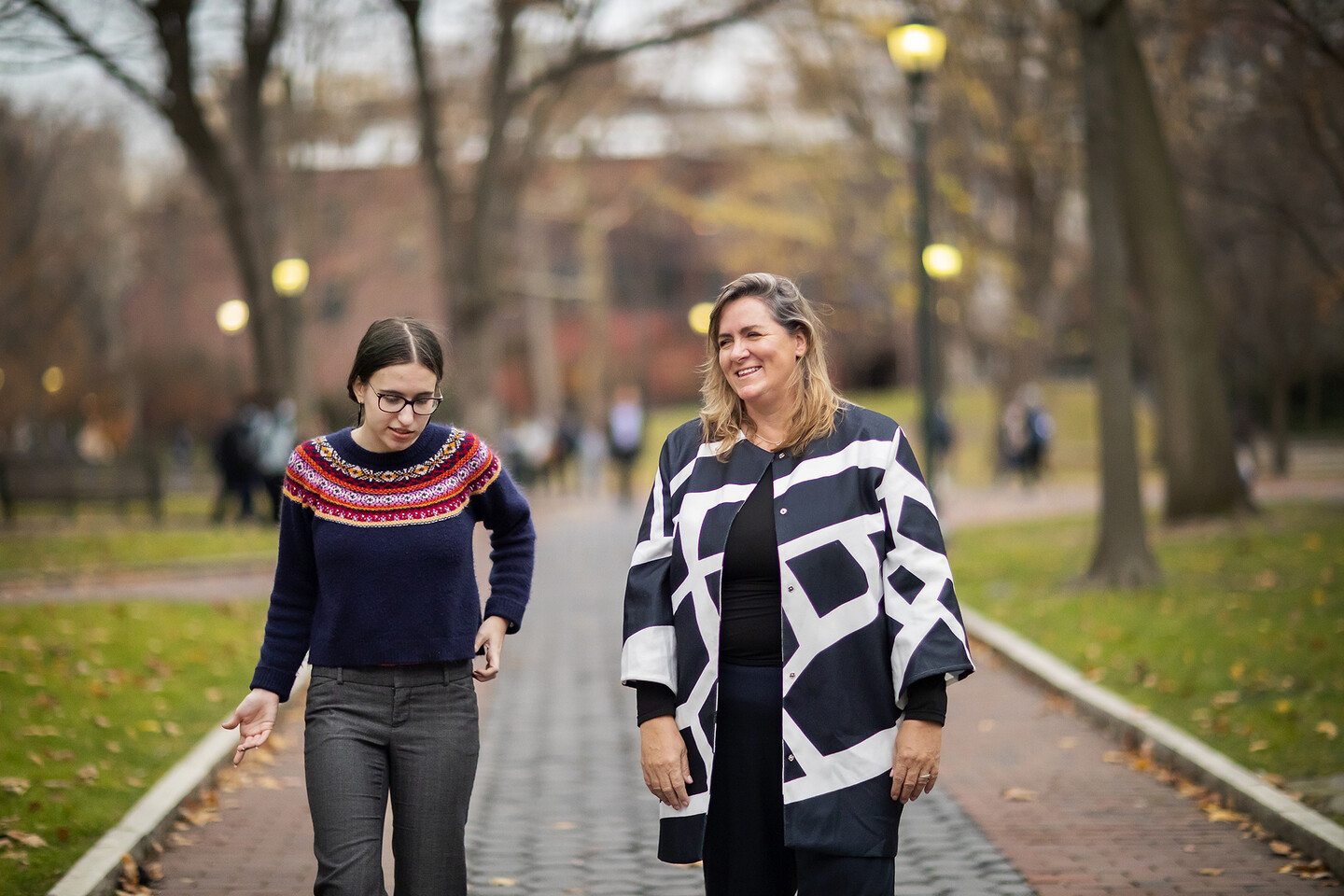 two people walking outside on brick walk