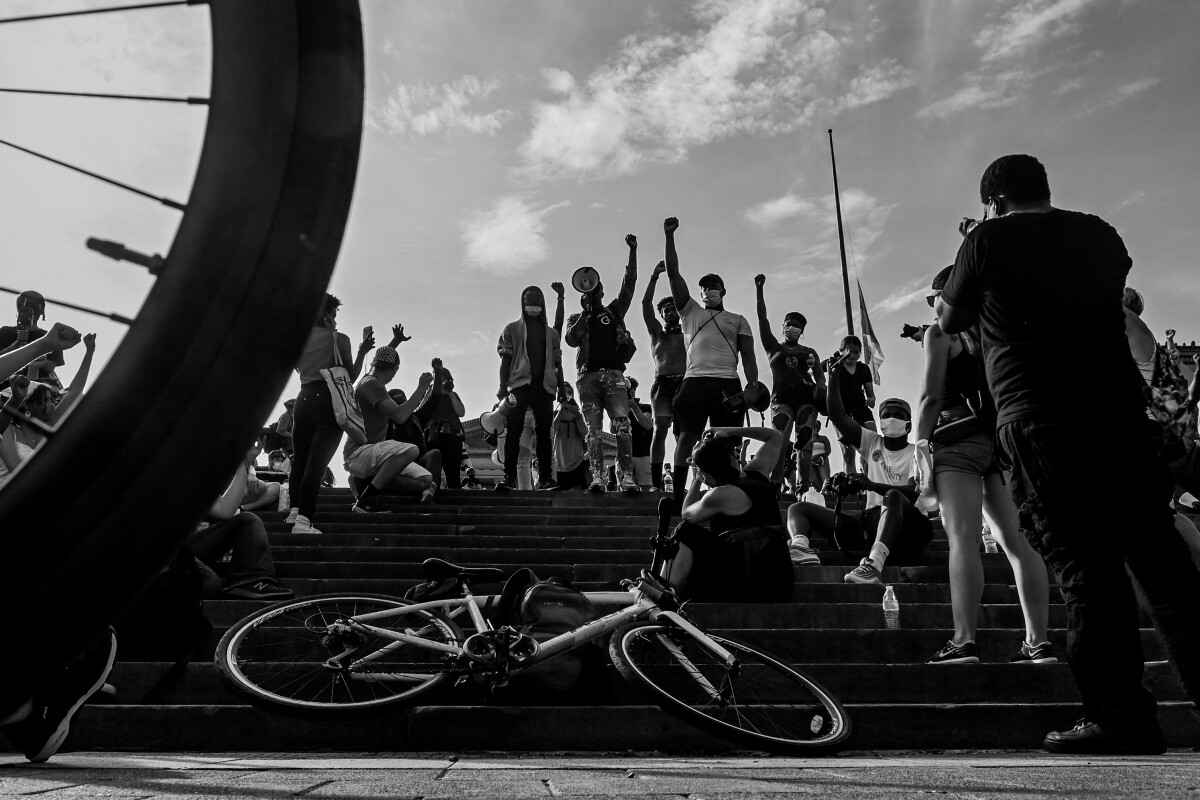 Protesters raise their fists on the steps of the Philadelphia Museum of Art.