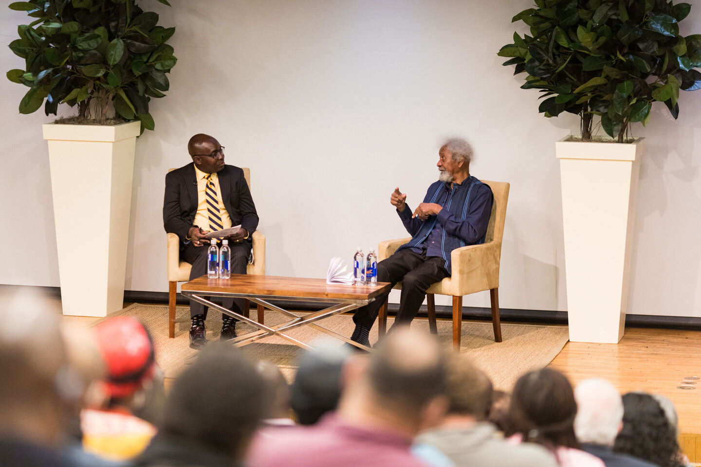 two people speaking on stage 