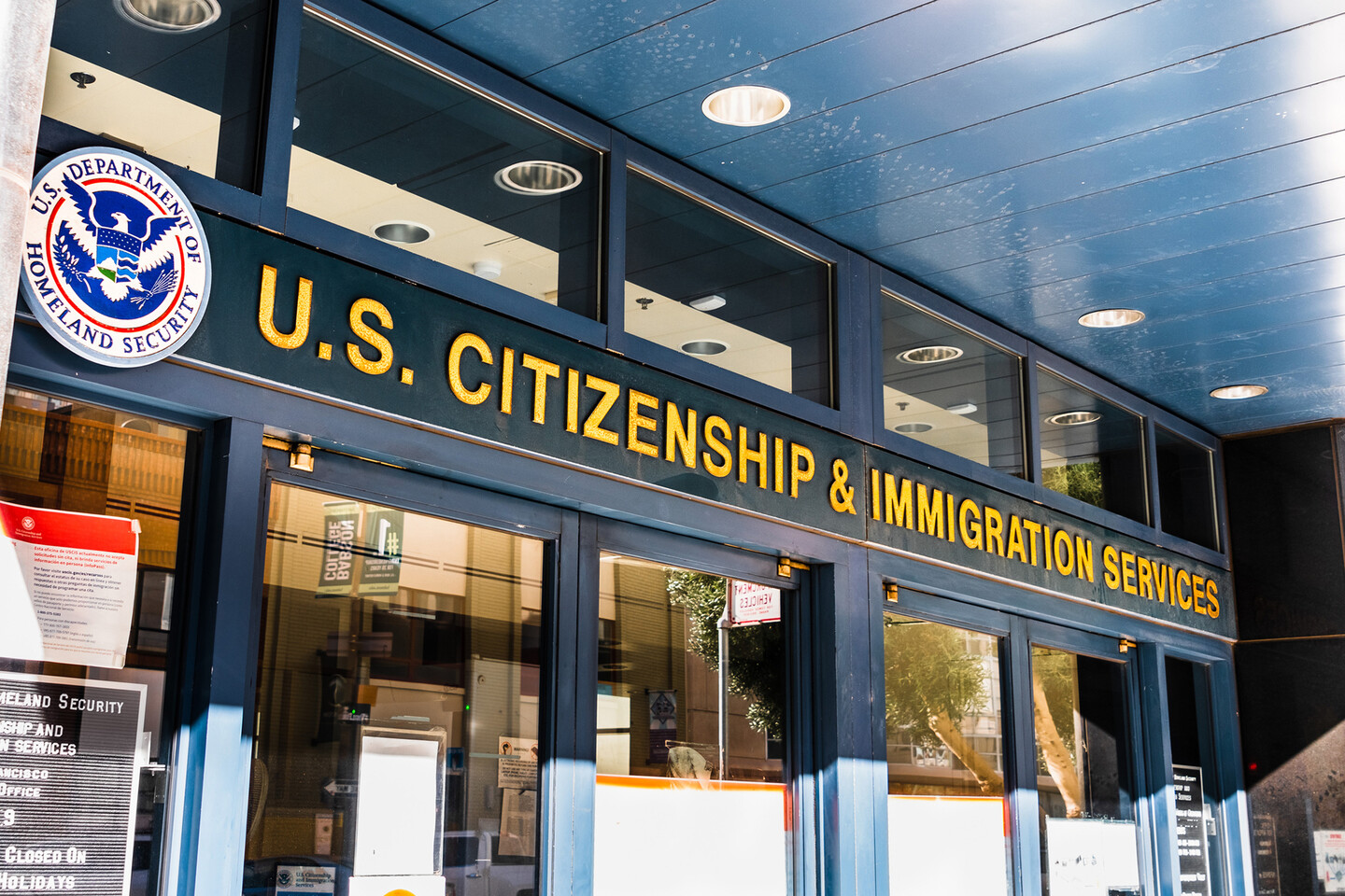 Outside of  a U.S. & Immigration building.