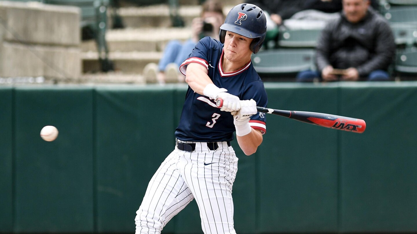 Appel prepares to swing at the ball as it approaches his bat.