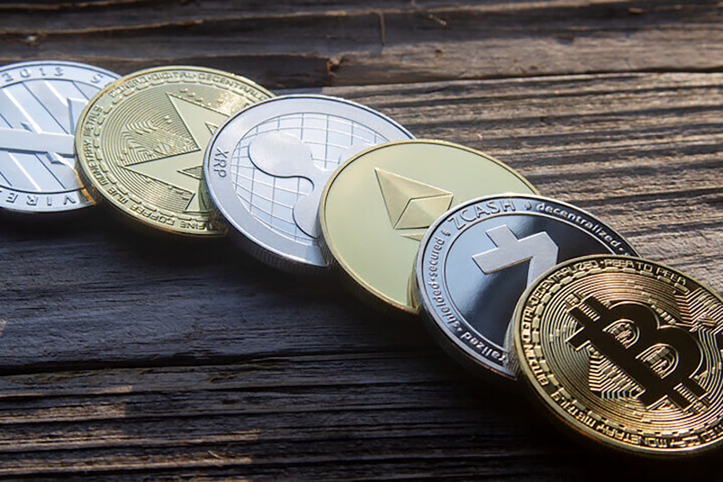 Six coins laid out on a flat surface.
