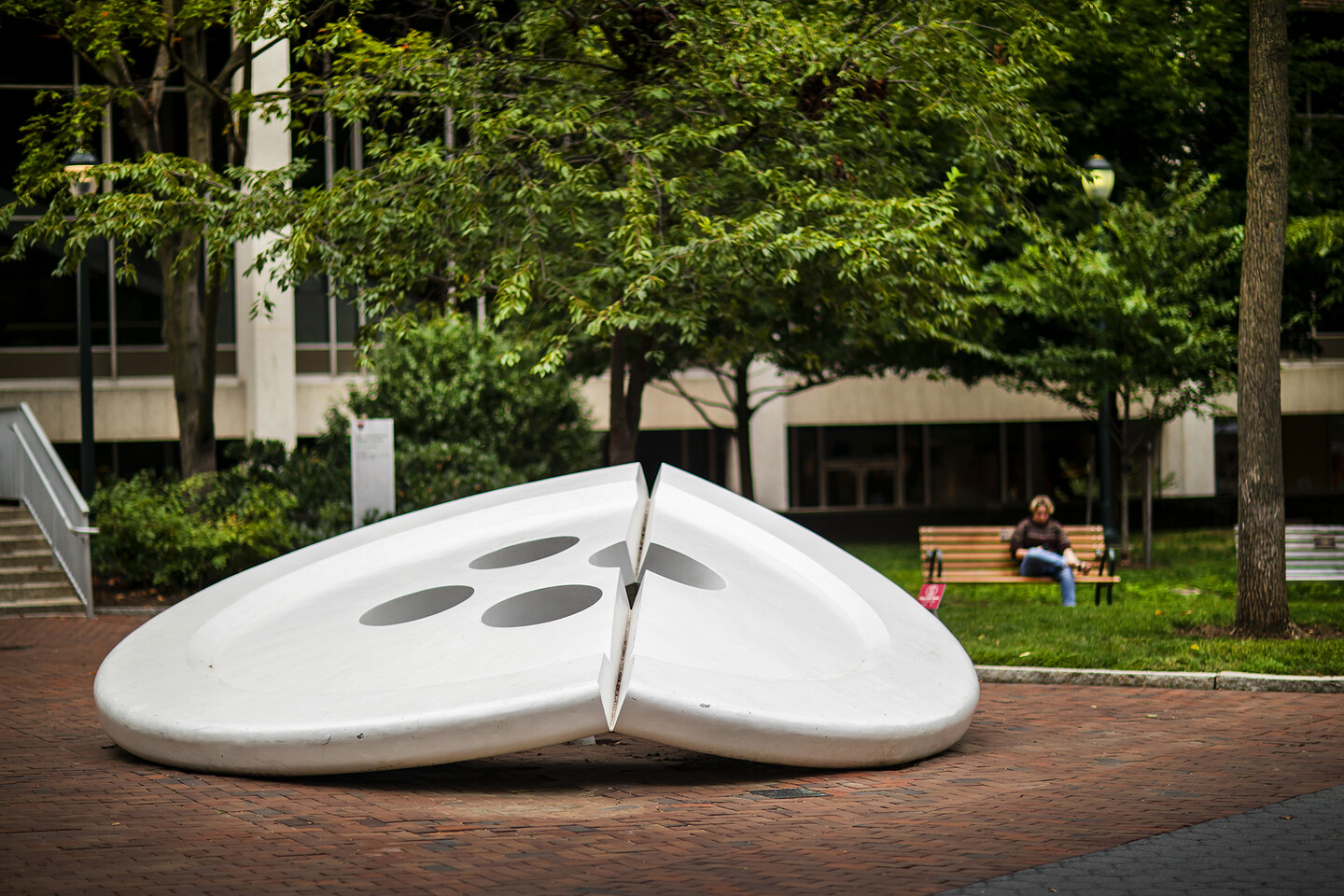huge sculpture of a button split in half