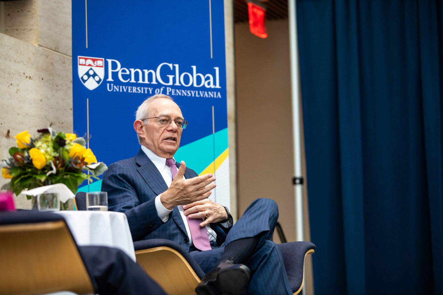 Rafael Reif on stage with Penn Global on sign behind him
