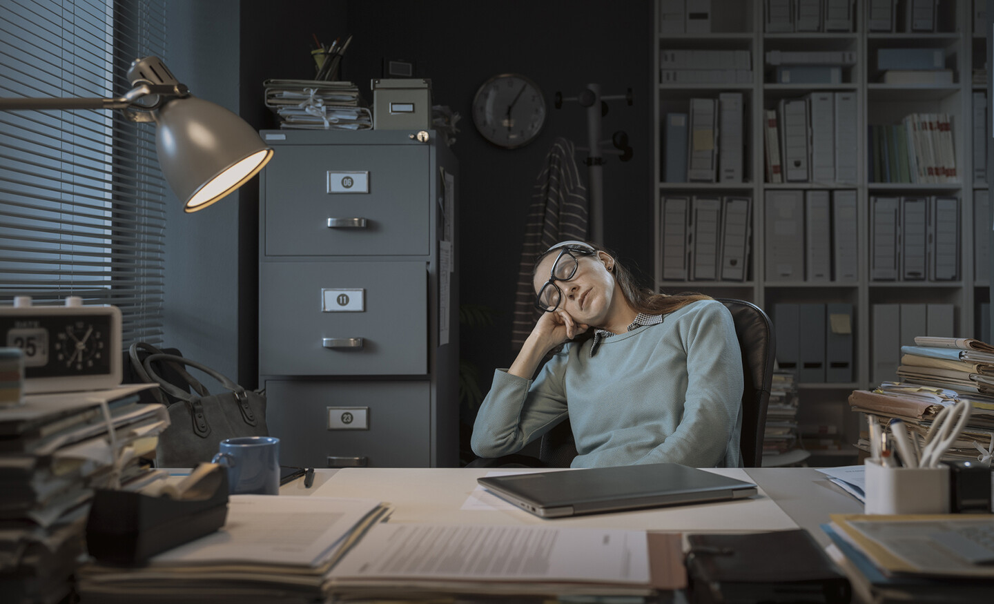 Person asleep at an office desk.