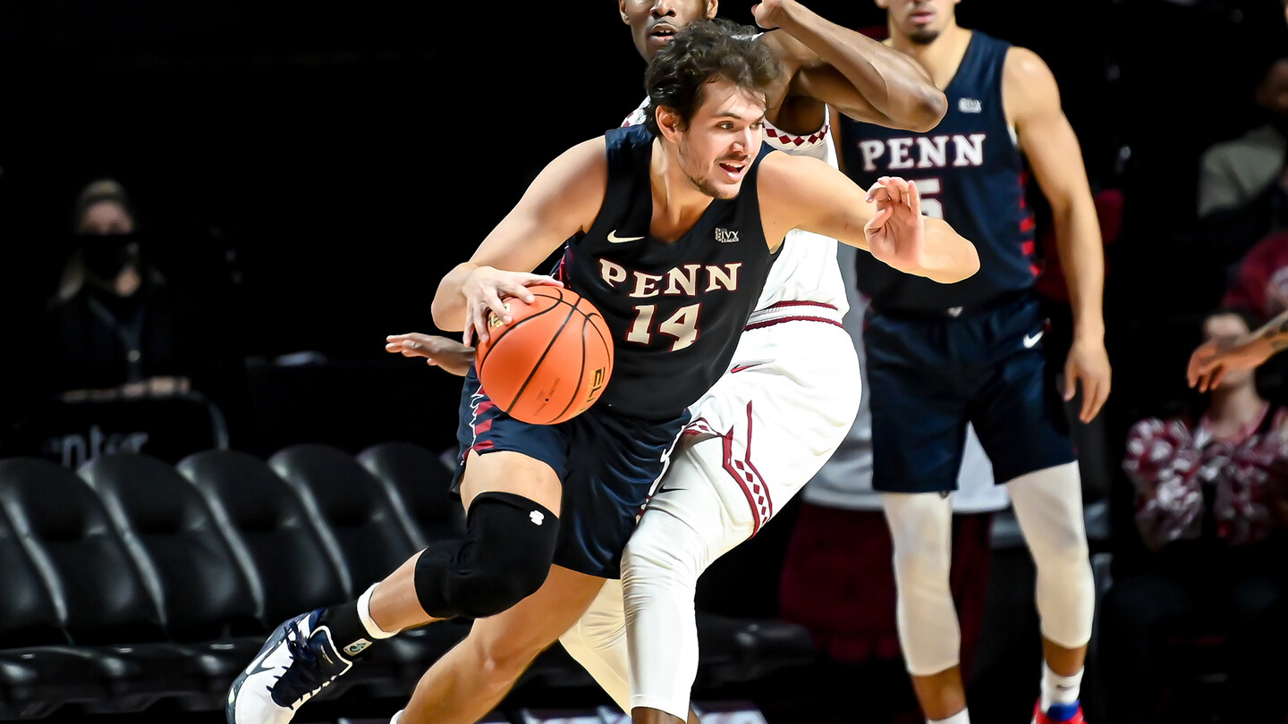 Max Martz drives to the basket while guarded by a defender.