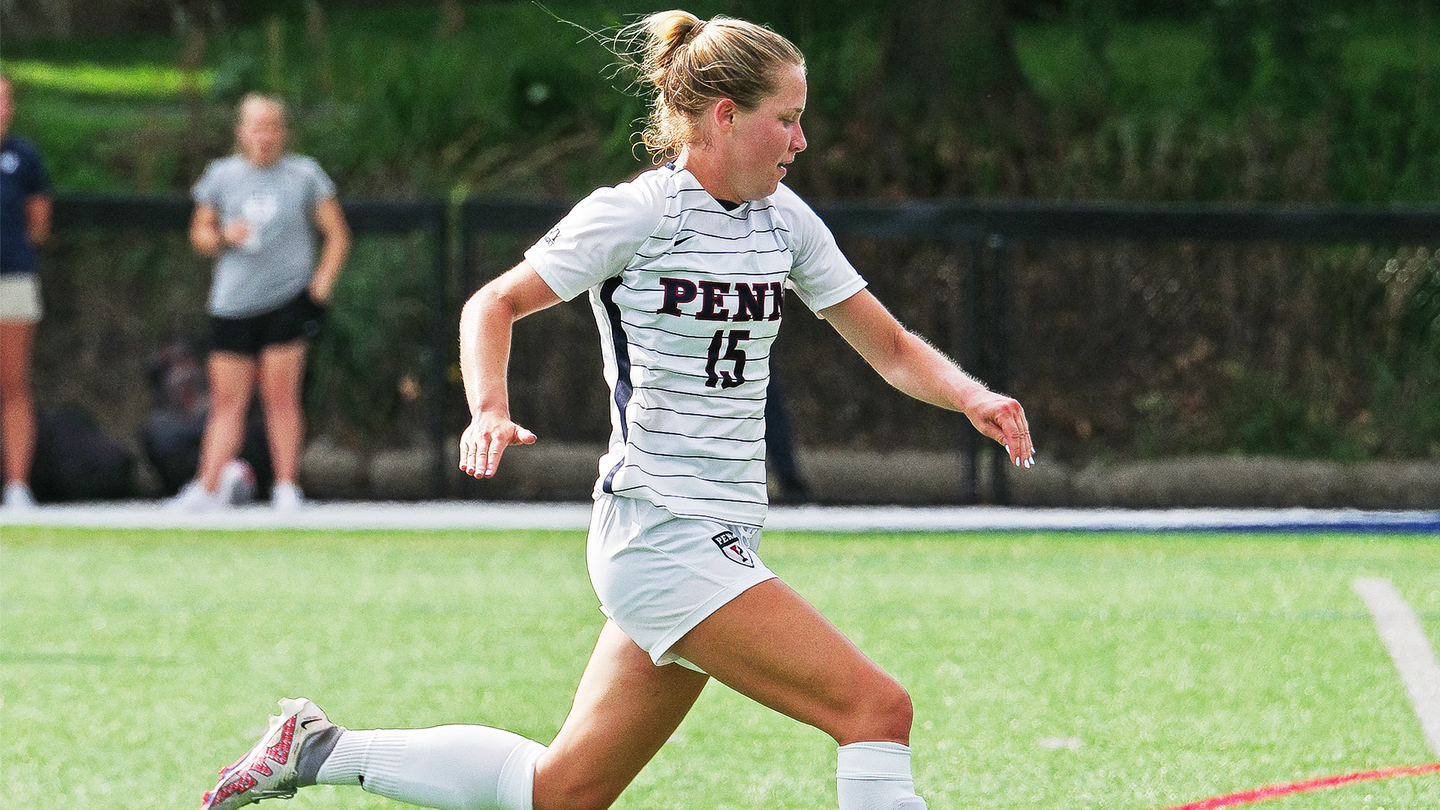 Third-year forward Isobel Glass kicks the ball down the field.