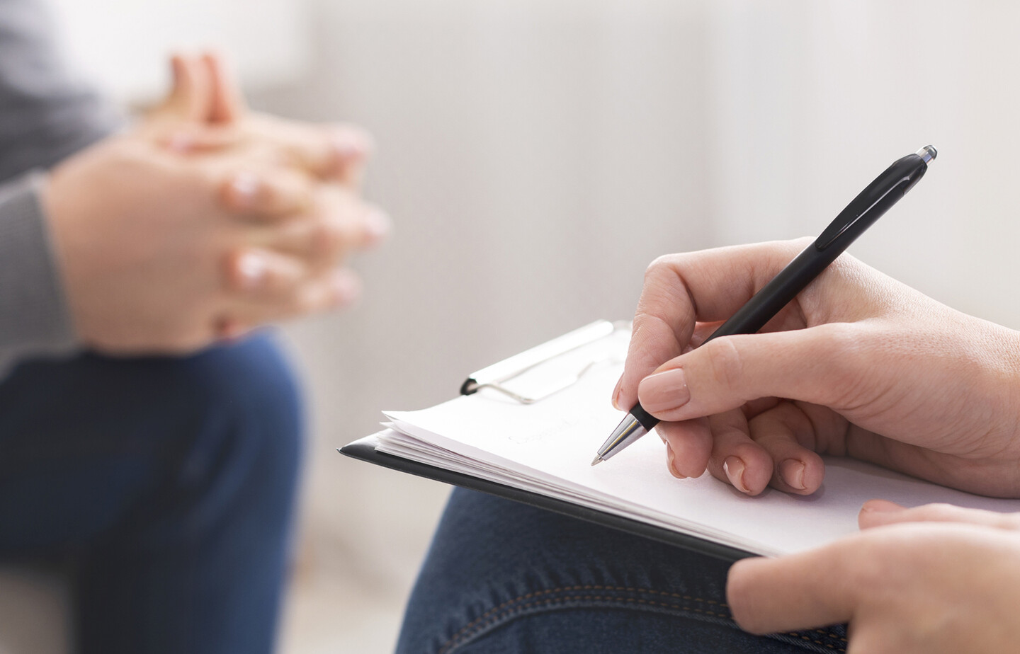 Therapist writes notes during session.