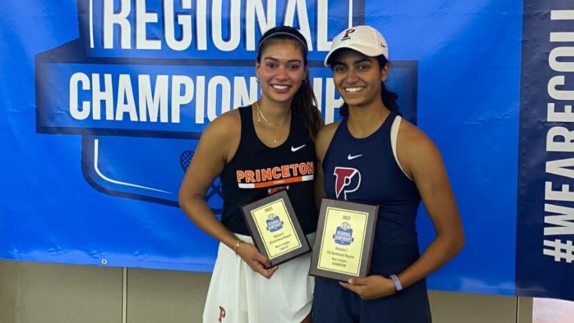 Esha Velaga, right, and Neha Velaga hold their trophies
